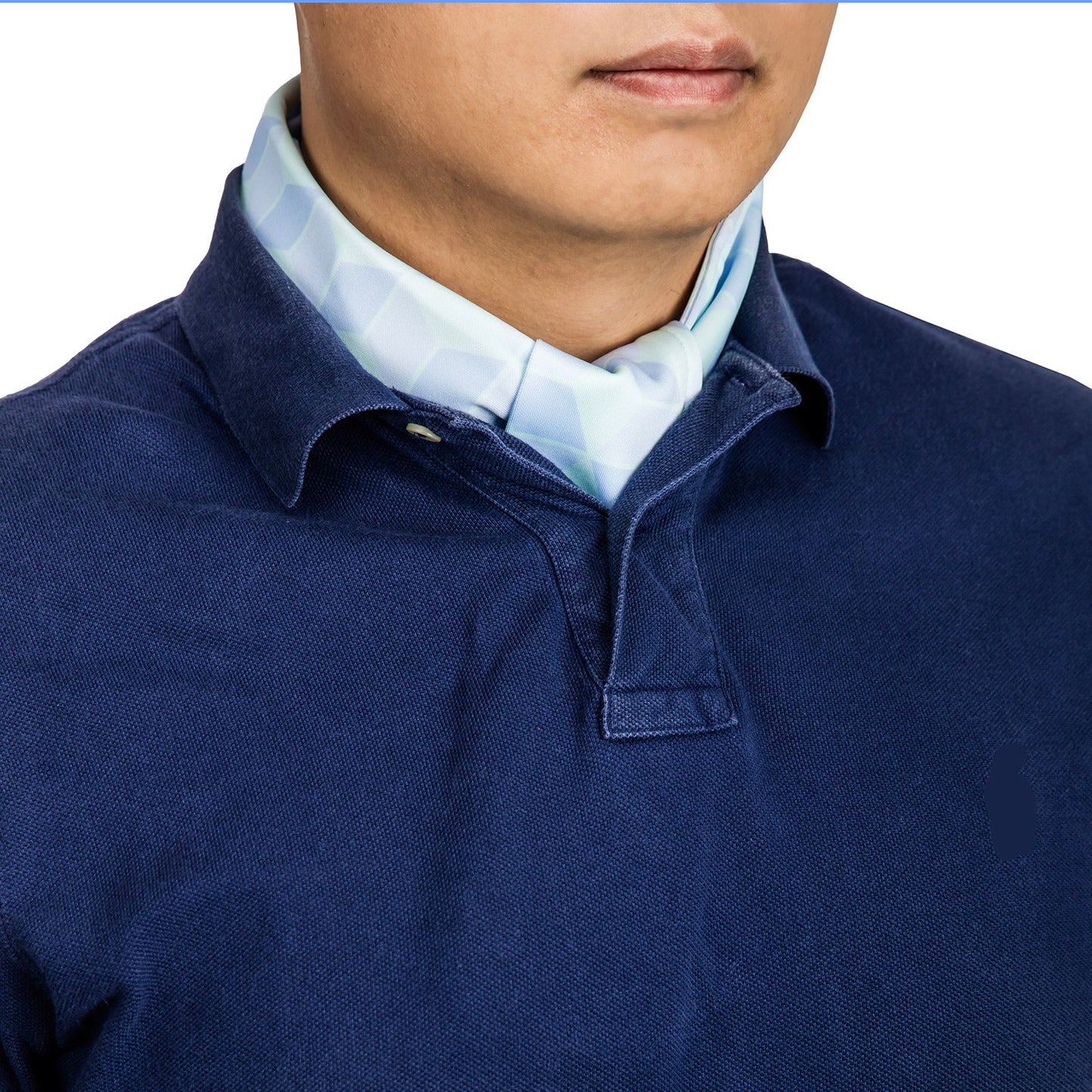 Cooling neck scarf with cubic pattern worn discretely under a polo shirt for hot-weather casual comfort