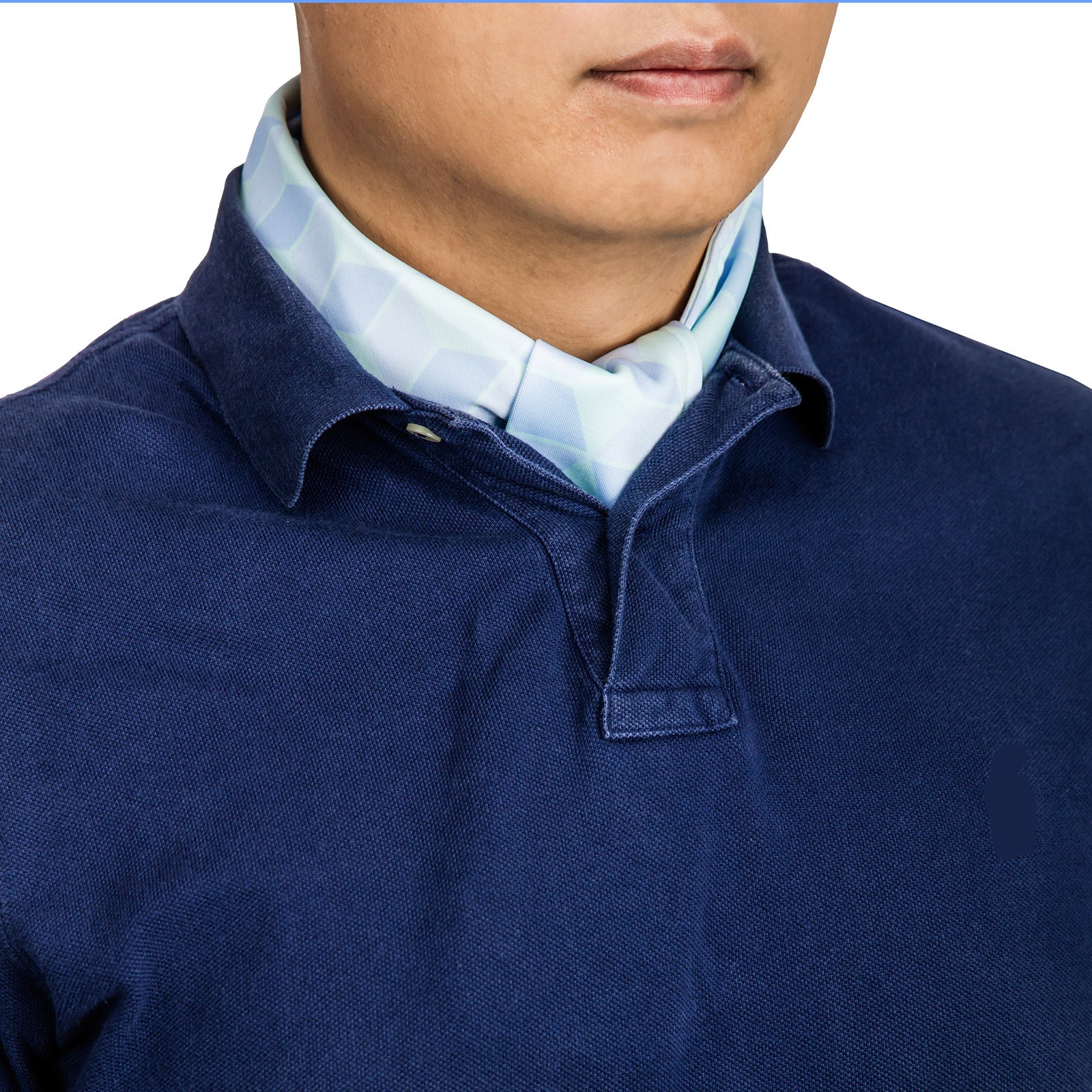 Cooling neck scarf with cubic pattern worn discretely under a polo shirt for hot-weather casual comfort